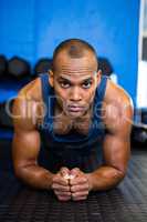 Serious sporty athlete exercising in gym