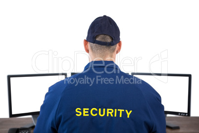Rear view of security officer using computer