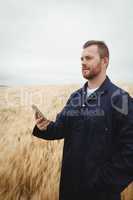 Farmer using mobile phone in the field