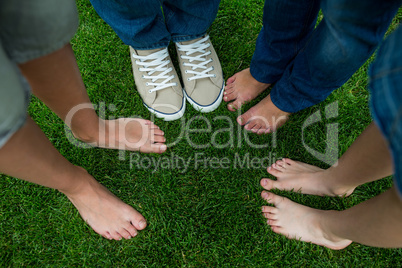Family standing on grass in park