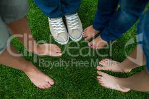 Family standing on grass in park