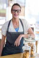 Portrait of waitress standing at counter in cafÃ?Â©