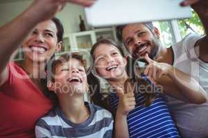 Happy family taking a selfie with digital tablet