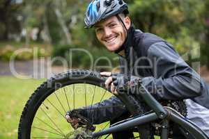 Male cyclist repairing his mountain bike