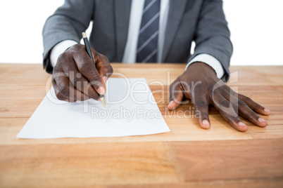 Businessman writing on a paper