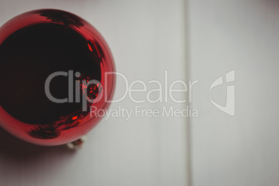 Red christmas bauble on wooden table