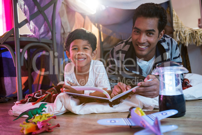 Father and son reading book