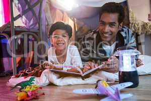 Father and son reading book