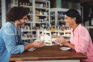 Couple smiling and holding coffee cup