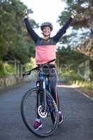 Female biker standing with mountain bike in country side