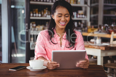 Beautiful woman holding digital tablet