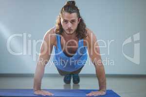 Man doing push-up on exercise mat