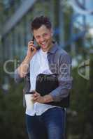 Handsome business executive talking on mobile phone