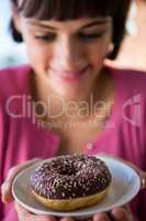 Woman holding a plate of doughnut