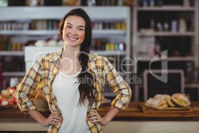 Portrait of woman standing behind the counter