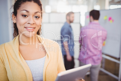 Portrait of executive using digital tablet at creative office