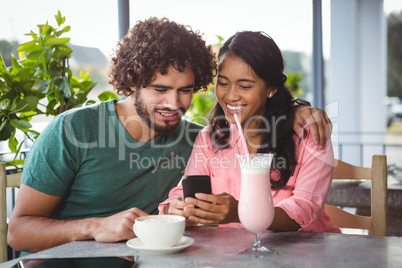 Couple looking at mobile phone