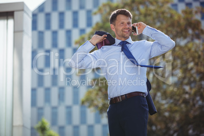 Handsome businessman talking on mobile phone