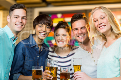 Group of friends having glass of beer in party