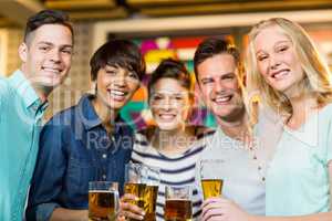 Group of friends having glass of beer in party