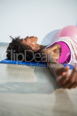Woman in yoga corpse pose