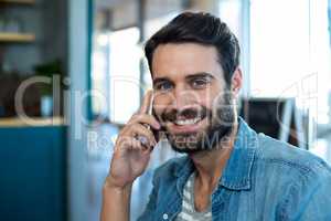 Smiling man talking on mobile phone