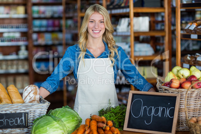 Smiling staff standing in organic section