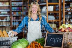 Smiling staff standing in organic section
