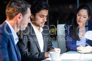 Group of businesspeople looking at document