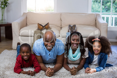 Portrait of happy family lying on the floor