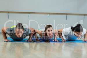 Group of fitness team doing push ups