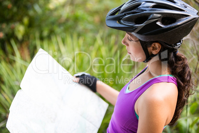 Female cyclist looking at map
