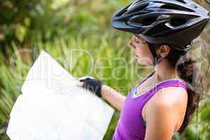 Female cyclist looking at map