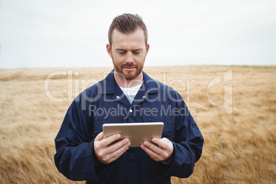 Farmer using digital tablet in the field