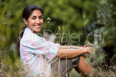 Female hiker sitting in forest