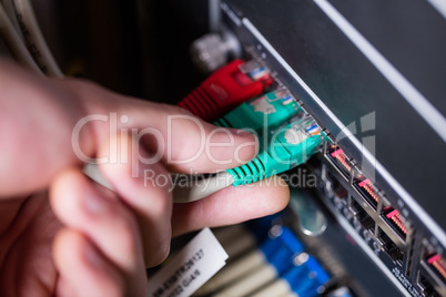 Technician plugging ethernet in a rack mounted server