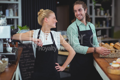 Waiter and waitress smiling at each other