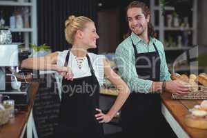 Waiter and waitress smiling at each other