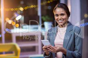 Businesswoman text messaging on mobile phone