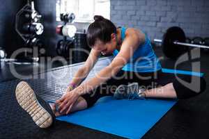 Young athlete stretching in gym