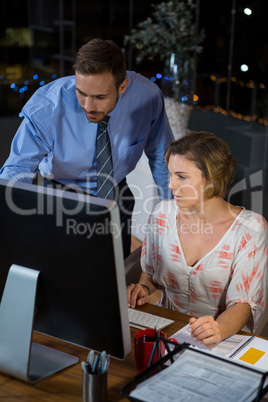 Business executives working on computer