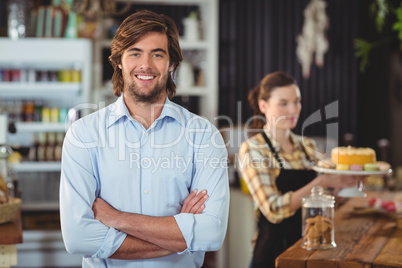 Smiling man standing behind the counter