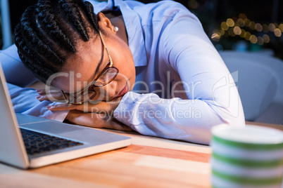 Tired businesswoman sleeping on the desk