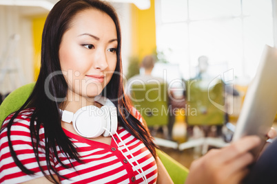 Happy executive using tablet at creative office