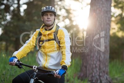 Male biker with mountain bike in forest