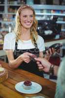 Customer giving credit card to waitress