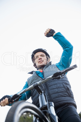 Excited male mountain biker in forest