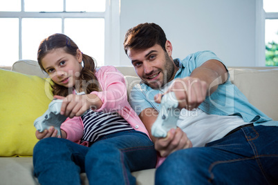 Father and daughter playing video game