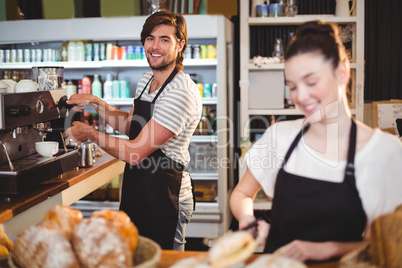 Waiter and waitress working behind the counter