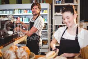 Waiter and waitress working behind the counter